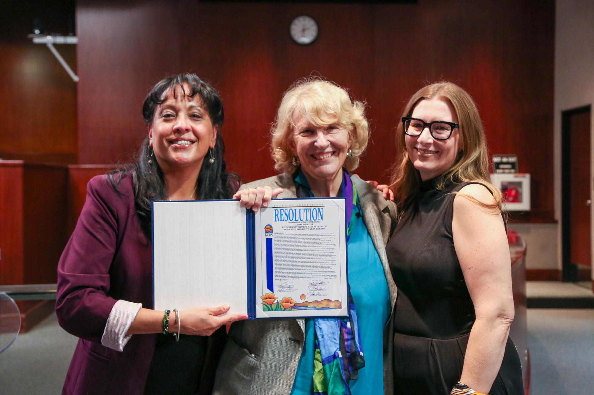 Supervisor Leticia Perez presenting a retirement resolution to Director of Kern County Planning and Natural Resources Lorelei Oviatt upon her retirement after 30 years of dedicated service