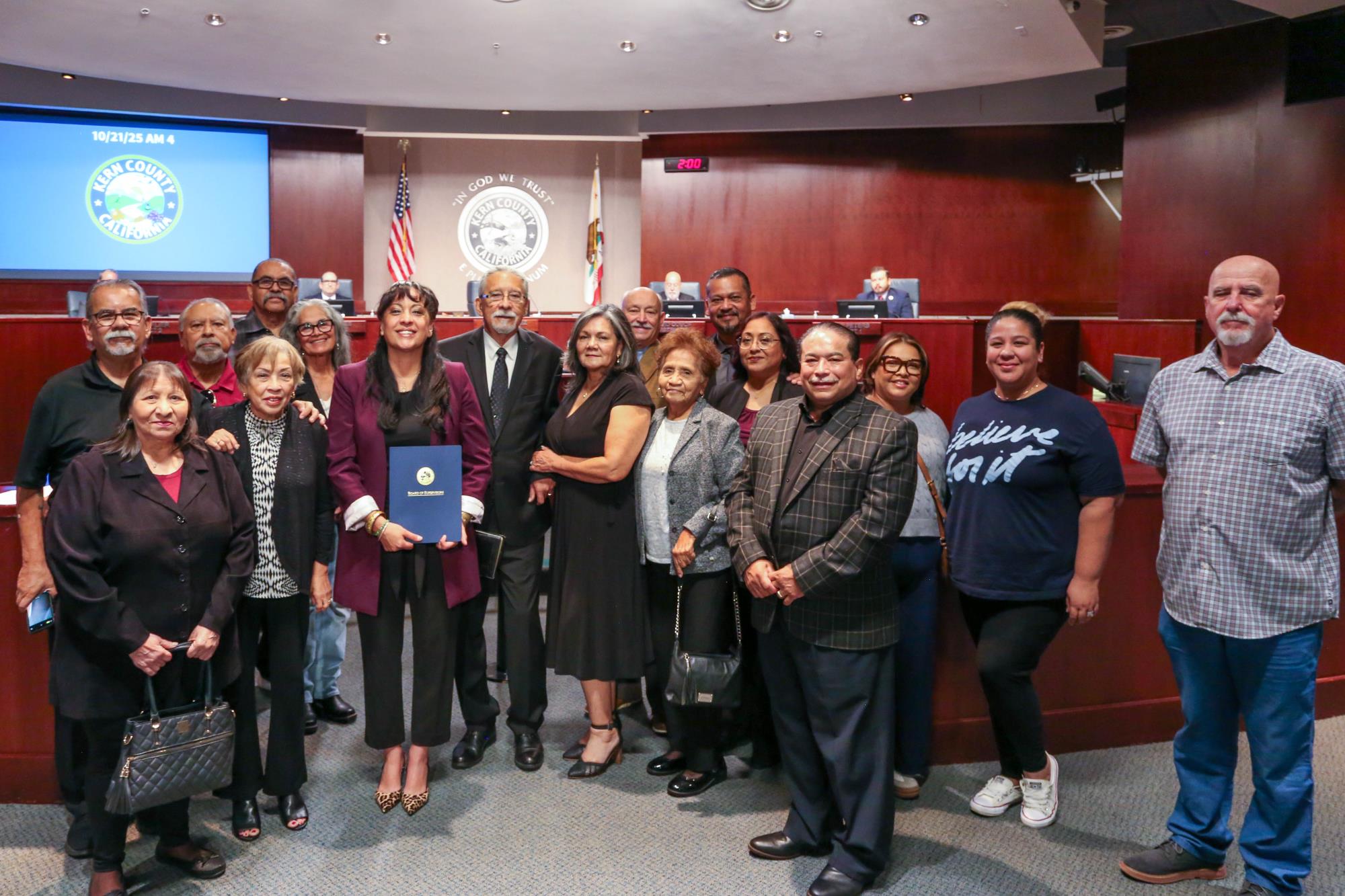 Photo of Board Chair presenting a certificate of recognition to Victor Perez for 50 years in ministry